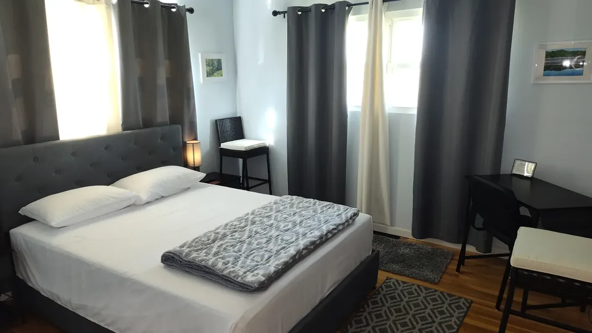 Remodeled queen bedroom interior of the Flannagan Lodge private guest suite in Haysi, Virginia