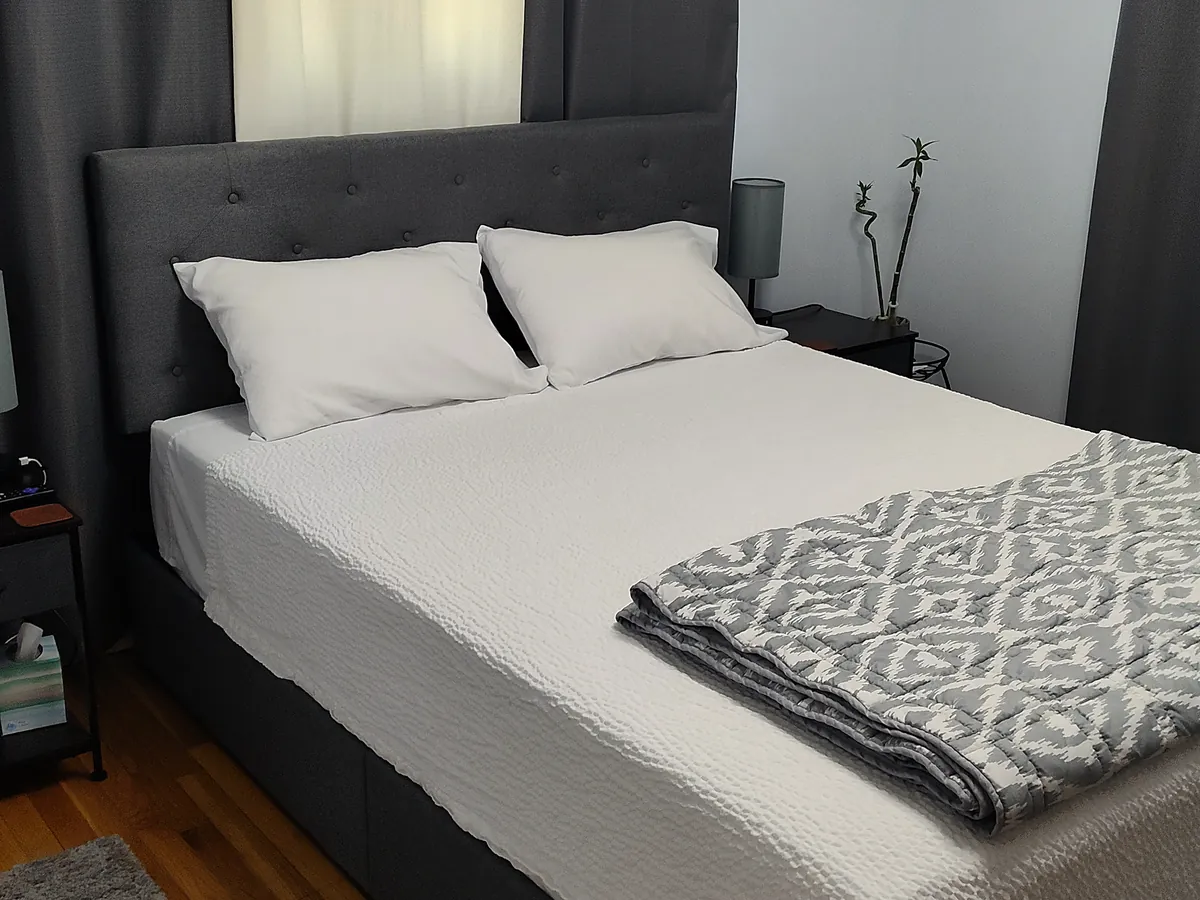 Second queen bedroom with a gray upholstered headboard at Flannagan Lodge in Haysi, Virginia