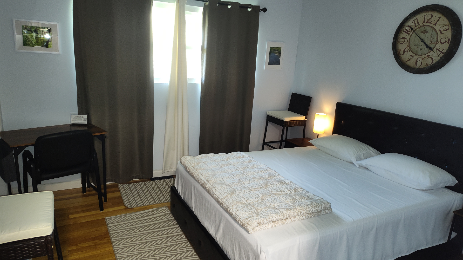 Suite bedroom with vintage wall clock and desk